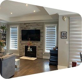 Living-room-with white-zebra-blinds- stone-fireplace-wall-and-mounted-TV